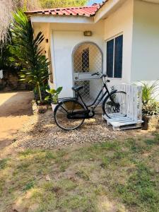 a bike parked in front of a house at Savita House Diani in Magutu