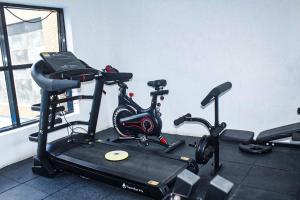 a gym with two exercise bikes on a treadmill at Dalos Unit in Ilado