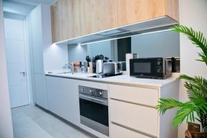 a kitchen with a stove and a microwave at Ad Astra Studio Apartment - Waterfall in Midrand