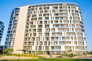 a tall white building with many windows at Ad Astra Studio Apartment - Waterfall in Midrand
