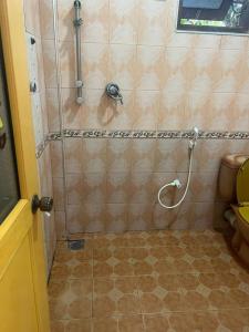 a shower in a bathroom with a tiled floor at Senuka Villa in Mirissa +18 photos