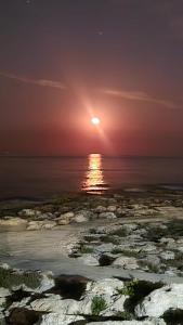 a sunset over the ocean with the sun setting at Maltese Sunshine in Naxxar