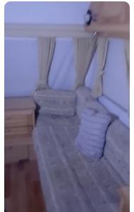 a small bedroom with a bed and a desk at Maltese Sunshine in Naxxar