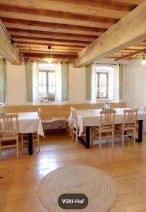 a large room with tables and chairs and windows at Völtl-Hof in Büchlberg +45 photos