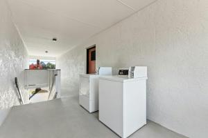 a kitchen with white appliances in a white wall at Red Roof Inn Panama City Beach in Panama City Beach
