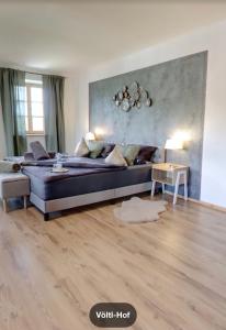 a living room with a large bed and a table at Völtl-Hof in Büchlberg