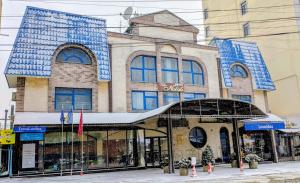 a building with blue tiles on it on a street at Hotel Villa Natali in Chişinău