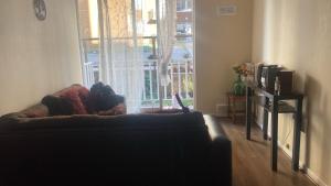 a living room with a couch in front of a window at departamento Eli in Valdivia +2 photos