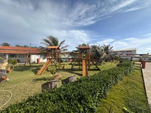 a playground in a park with trees and bushes at Juscelino Pousada lazer in Tibau
