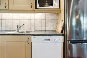 a kitchen with a sink and a refrigerator at Mountain Cabin With Great Views in Austbygdi
