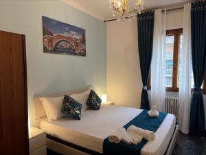 a bedroom with a bed and a chandelier at CA'venezia in Mestre