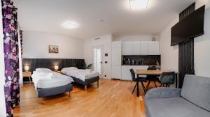 a living room with two beds and a table at Jasminn Apartments in Prague
