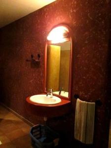 a bathroom with a sink and a mirror at Oloimala Mara Camp in Gatunga