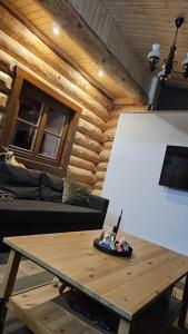 a living room with a table and a couch at Zrubová chata Jakub in Oravská Lesná +28 photos