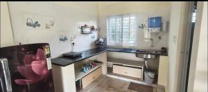 a small kitchen with a sink and a sinkessment at Nandi Holiday Homestay in Nandi