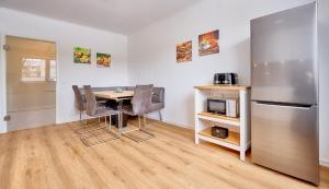 a kitchen with a table and a refrigerator at Haus Mühlentrift in Cuxhaven