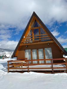 a log cabin in the snow with a sky at Villa Wood Borje in Žabljak