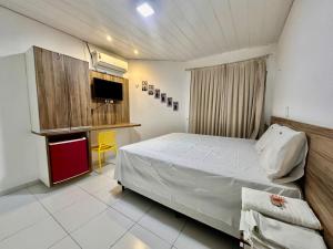 a bedroom with a bed and a tv in it at Juscelino Pousada lazer in Tibau