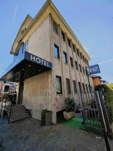 a building with a hotel sign on the side of it at Hotel Zara Milano in Milan