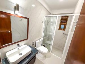 a bathroom with a toilet and a sink and a shower at Windsor Crest in Kandy