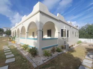 a white house with a blue and white facade at Sunny Bluu Villas in Meads Bay