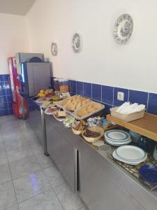 a buffet line with plates and bowls of food at Hotel JSF in Horta +15 photos