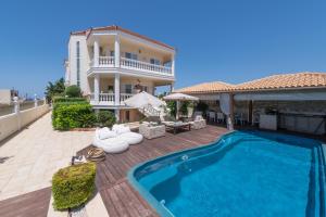 a villa with a swimming pool and a house at Marilyn Manor, Exclusive Hideway, By ThinkVilla in Gouves