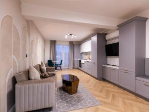 a living room with a couch and a table at Nubia Central Apartments in Bistriţa