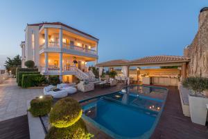 a house with a swimming pool in front of it at Marilyn Manor, Exclusive Hideway, By ThinkVilla in Gouves