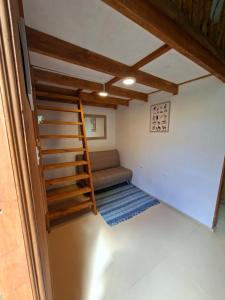 a living room with a couch and a staircase at Refugio Purrunko in Pucón