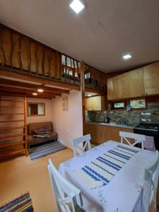 a kitchen with a table and chairs in a room at Refugio Purrunko in Pucón +3 photos