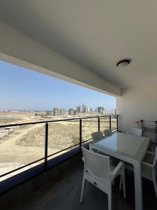 a room with a table and chairs and a large window at Caesar Resort & SPA - Apartments with 1 Bedroom in Iskele