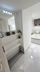 a room with white walls and stairs with a bed at Vacation Liberation Apartment in Split
