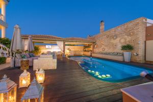 a house with a swimming pool and a patio at Marilyn Manor, Exclusive Hideway, By ThinkVilla in Gouves +36 photos