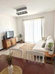 a living room with a bed and a table at R Haus 2 Con Cochera in Concordia