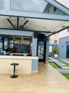 a bar with a stool in front of a building at 2020 Apartment Katampe in Mama