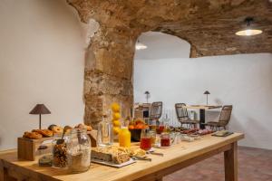 a table with bread and other food on it at BYPILLOW Cluc Begur in Begur +34 photos
