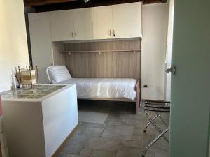 a bedroom with a bed and a kitchen with a table at Ancient village in Trieste +14 photos