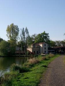 a house next to a river with a building at Les Clés Nature Studio 41 in Moutiers-sous-Chantemerle