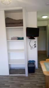 a room with a closet with a bed and a tv at Les Clés Nature Studio 41 in Moutiers-sous-Chantemerle