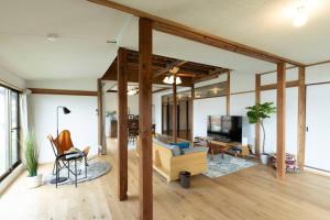 a living room with a couch and a tv at 太宰府らたん - Dazaifu Ratan in Dazaifu