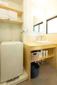 a bathroom with a sink and a white refrigerator at 太宰府らたん - Dazaifu Ratan in Dazaifu +26 photos