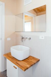 a bathroom with a white sink on a wooden counter at Locanda dell'Ortolano in Ferrara