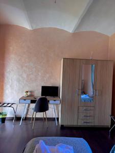 a bedroom with a desk and a computer in a cabinet at Albergo Vecchio Pavone in Borgaro Torinese +21 photos