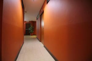 a hallway with orange walls and a tile floor at Super OYO 484 Pannee Residence Khaosan Sha Plus in Bangkok +27 photos