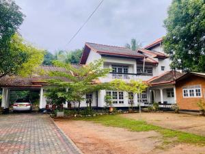 a house with a car parked in front of it at #BEDBOX in Dambulla