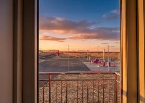 a view of an empty parking lot from a window at Faxaflatir Apartments in Hella +6 photos