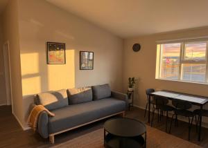 a living room with a couch and a table at Faxaflatir Apartments in Hella