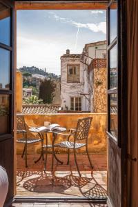 a view of a table and chairs from a window at BYPILLOW Cluc Begur in Begur