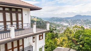 a house with a balcony overlooking a city at Windsor Crest in Kandy